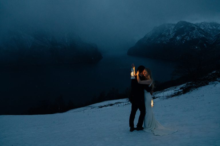 Winter elopement in Norway. Stunning blue hour with falling snow. By Christin Eide Photography