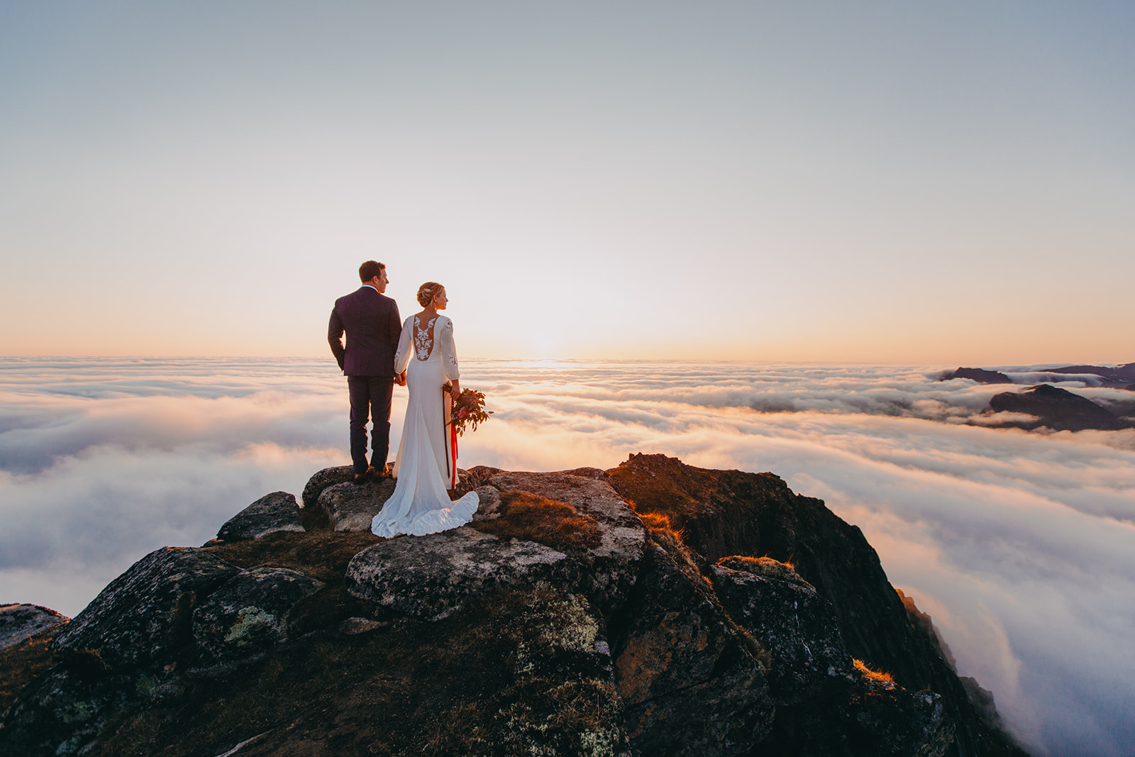 Eloping under the midnight sun. Above the clouds. Lofoten, Norway. By Christin Eide Photography
