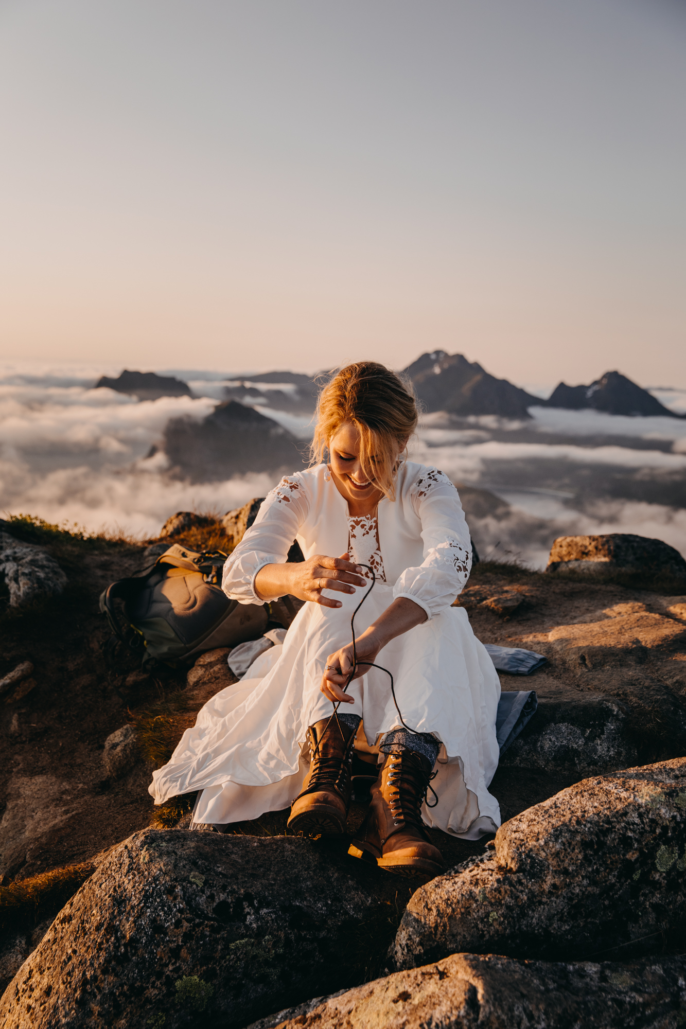 Getting ready above the clouds. Midnight sun elopement in Lofoten, Norway. By Christin Eide Photography