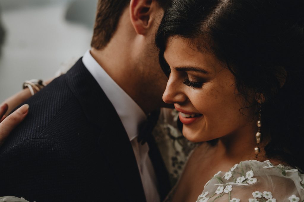 Close up of beautiful bride and groom embracing during their elopement wedding in Aurland, Norway, photo by Christin Eide Photography