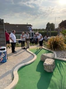 A photograph of Club Members playing Crazy Golf on Clacton Seafront