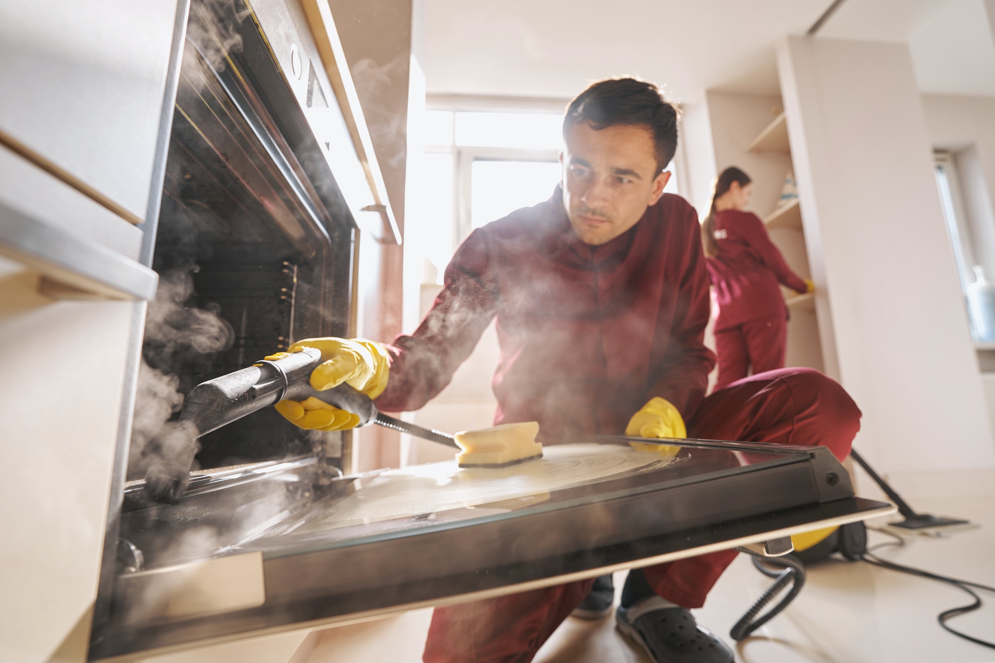 Professional janitorial personnel doing eco-friendly kitchen cleaning