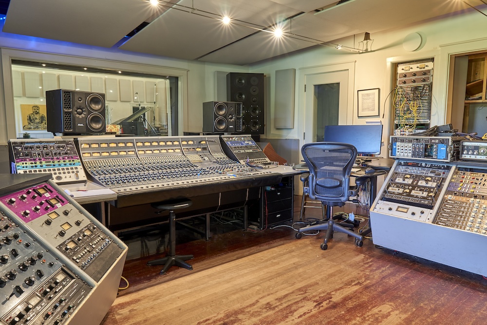 The classic 28-channel Neve 8058 Mk II console in the Clubhouse control room, with rolling racks of outboard gear and custom Ted Rothstein main monitors, along with a set of PMC 6.2s and Yamaha NS-10s. Photo: Mike Dwyer.