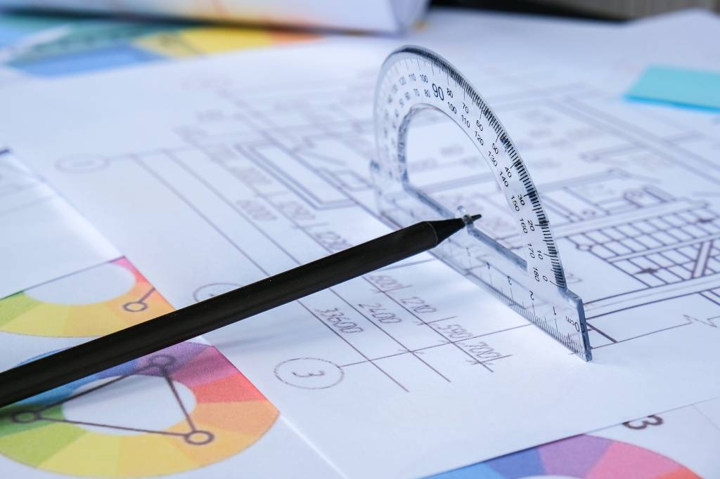 A pencil with a protractor. Architectural Project drawings with tools. Architects workplace. Enginee