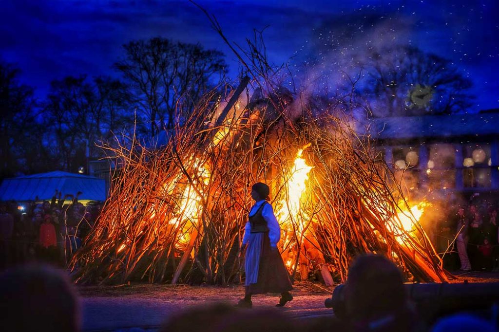 Woman walking in front of Walpurgis fire