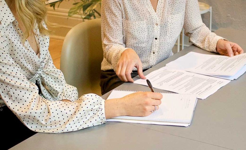 Women's hands writing a letter