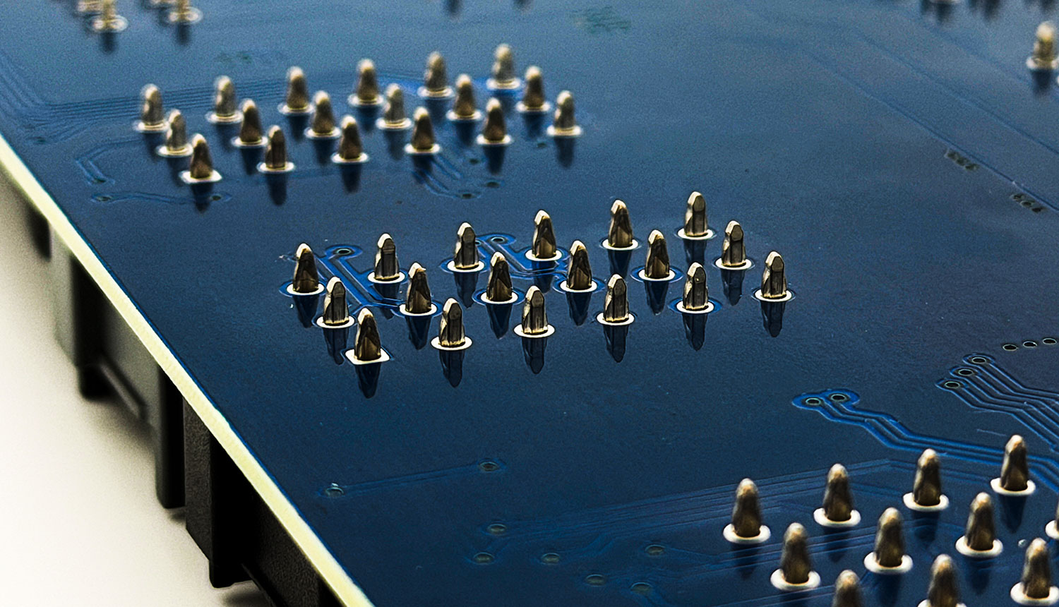 Press-fit terminals installed in plated through-holes on a PCB