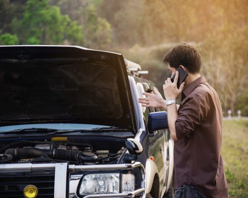 Man try to fix a car engine problem on a local road Chiang mai Thailand - people with car problem transportation concept