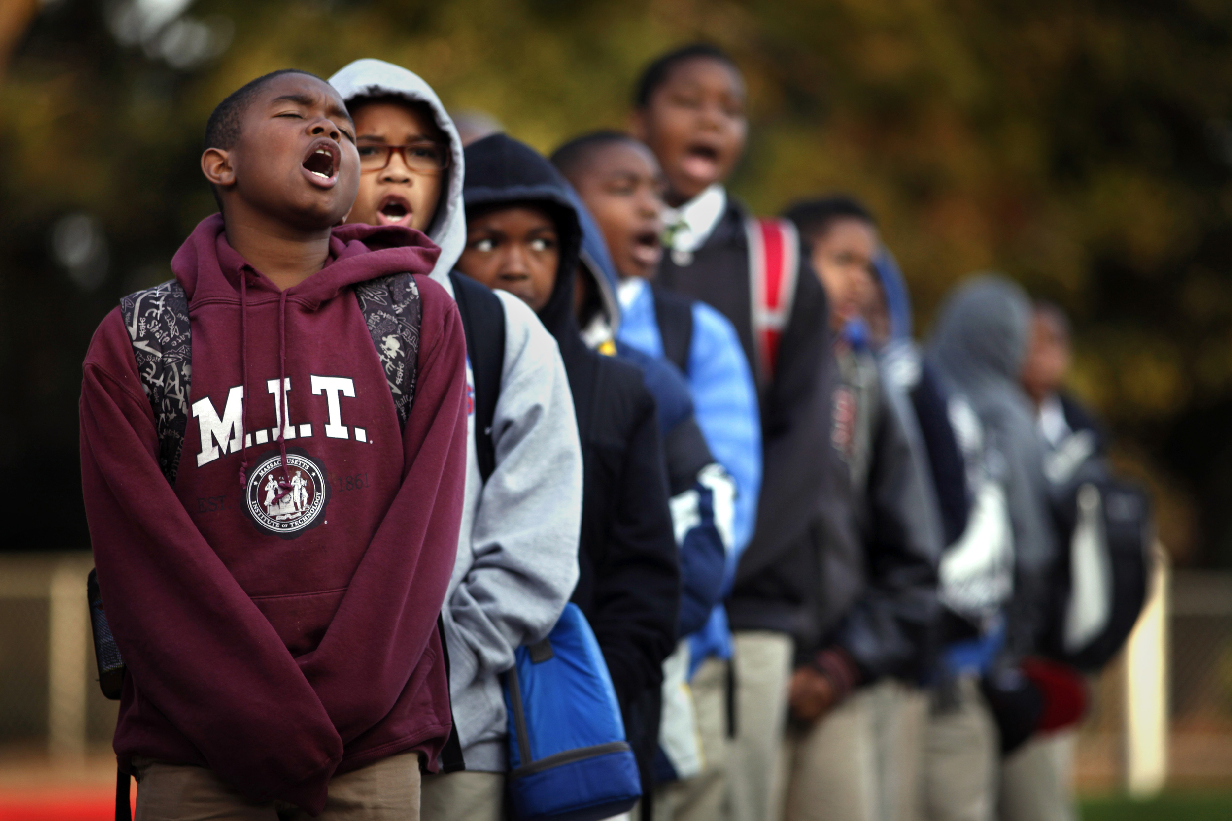 Imir Stills-Bey, left, Donavon Richard and Kavion Hammond lead Mr. Peter Wilson's sixth-grade class in the "scholar holler" at the start of school. The chant is done every morning before class at the 100 Black Men Community Charter School to promote a eagerness for learning.