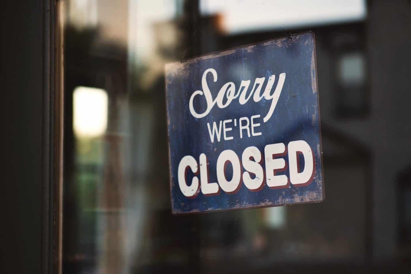 Sorry we're closed sign in glass door