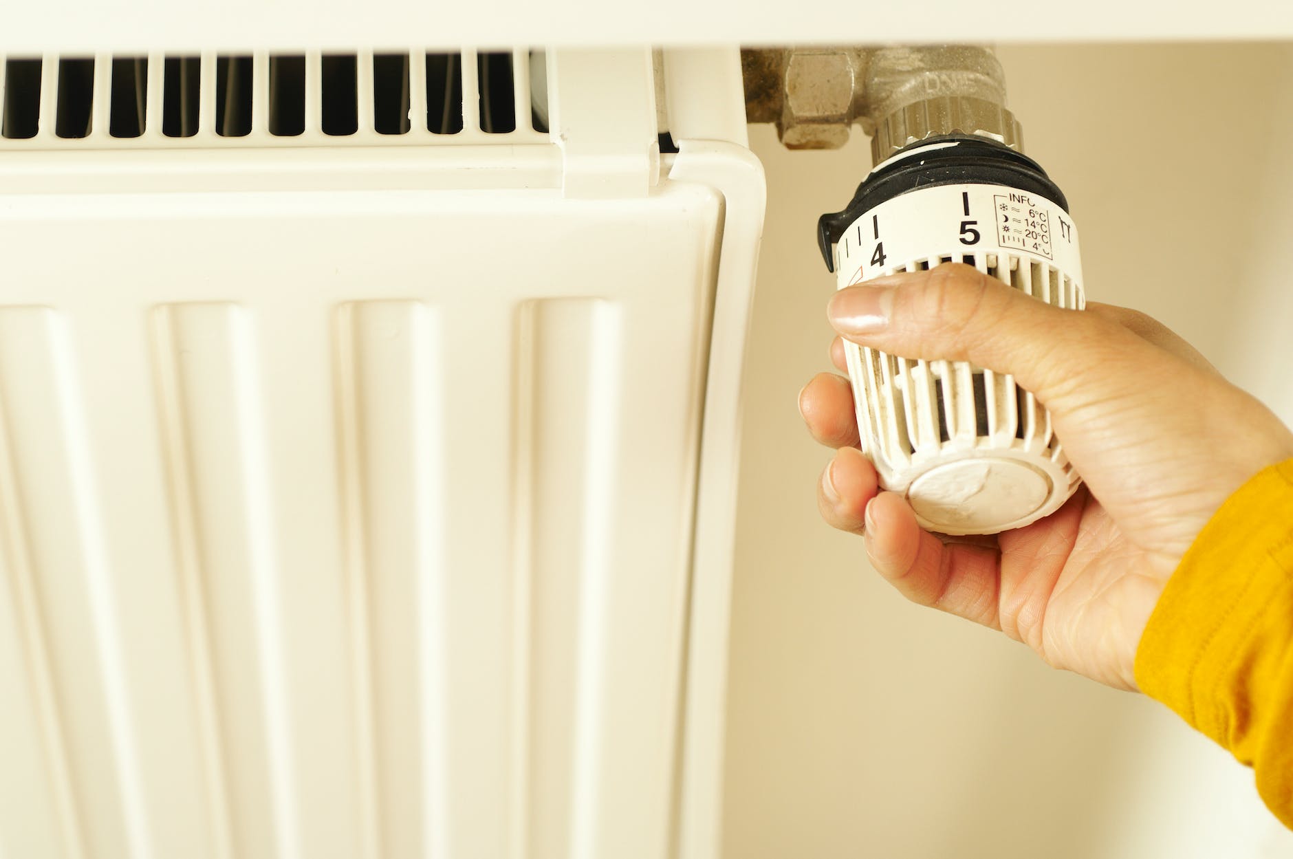 hand of a person turning the radiator valve