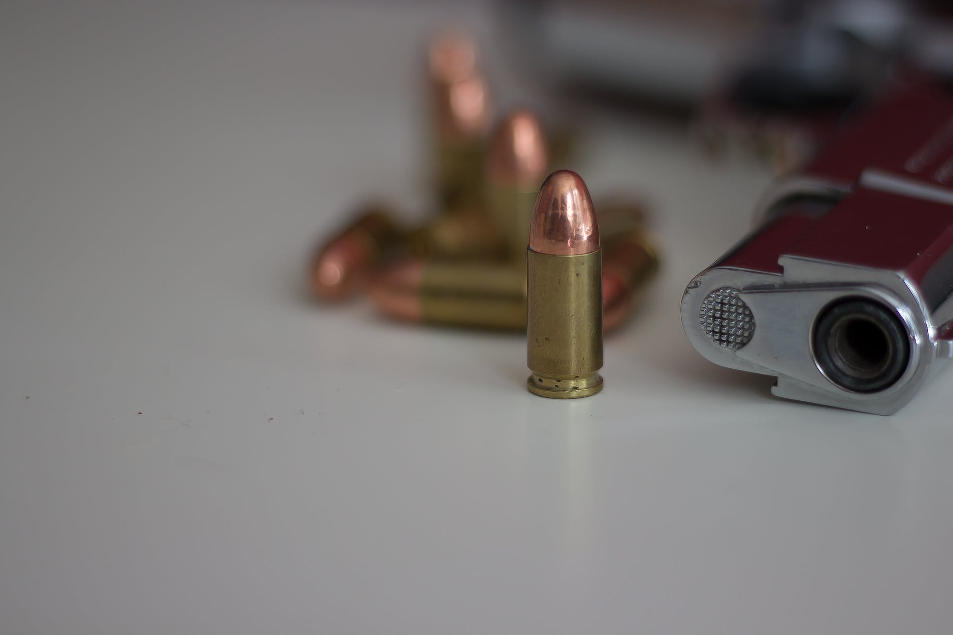 close up of bullet beside a gun