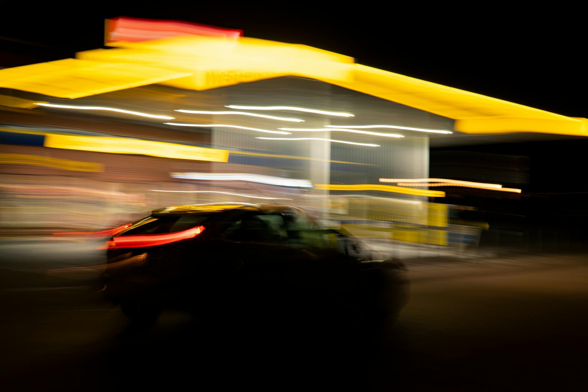 car passing a gas station