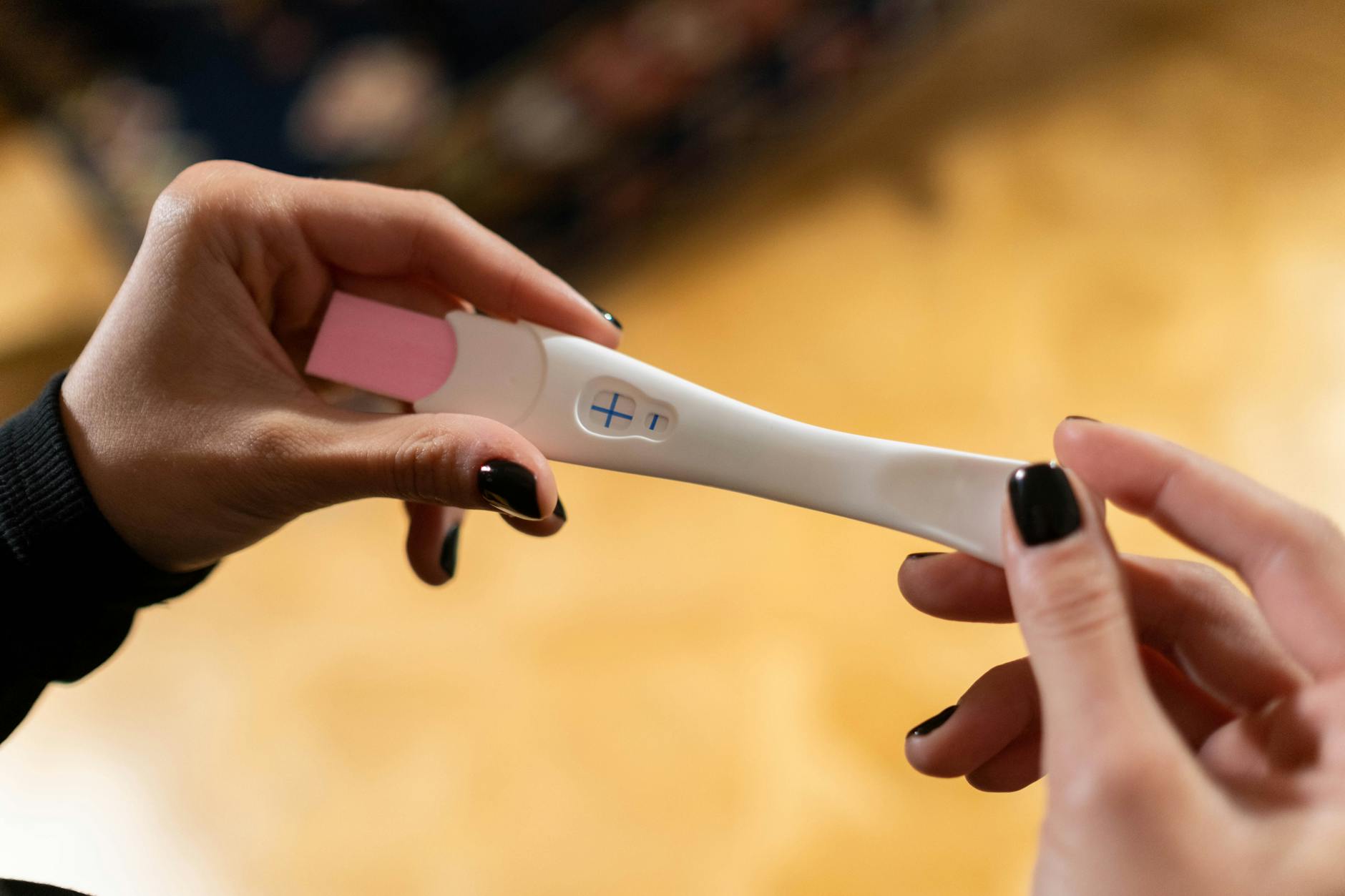 hands holding pregnancy test kit