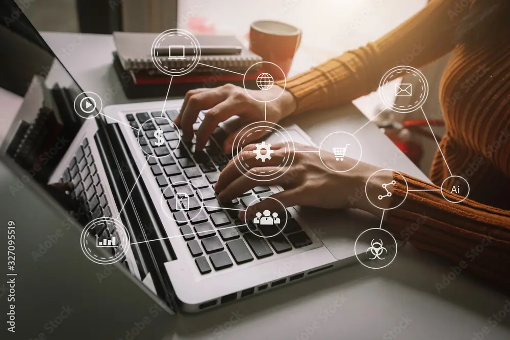Woman using laptop with digital marketing and artificial intelligence icons overlay.