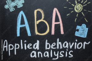 Text ABA Applied behavior analysis and drawings on blackboard