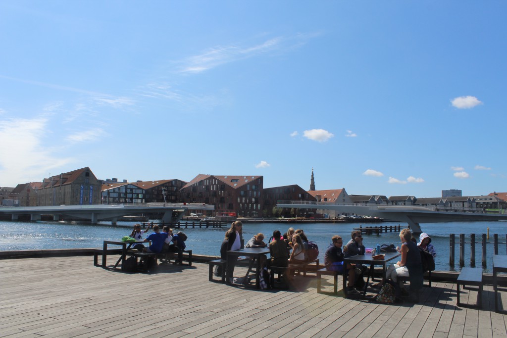 Copenhagen Inner Harbour - relaxed atmosphere in from of New Copenhagen Opera built 2005. View to nes walk- and bike slide bridge "Inderhavnsbroen". Pg