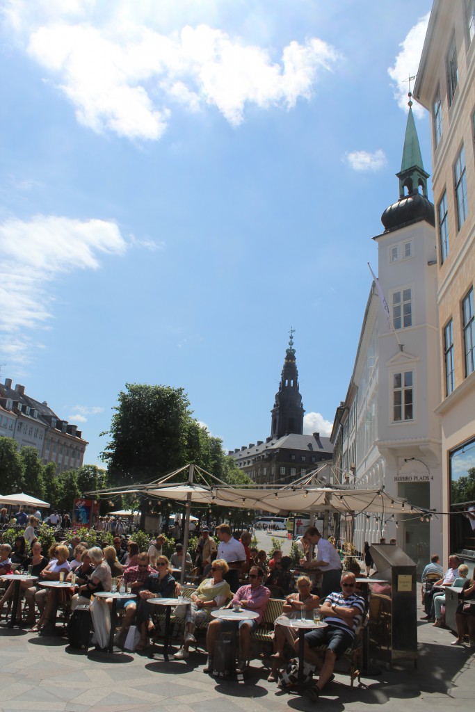 Amager Square - lunch on restaurants. View in direction to Christiansborg Castle builded 1906-26: The Danish parliament, High Court and Government administration