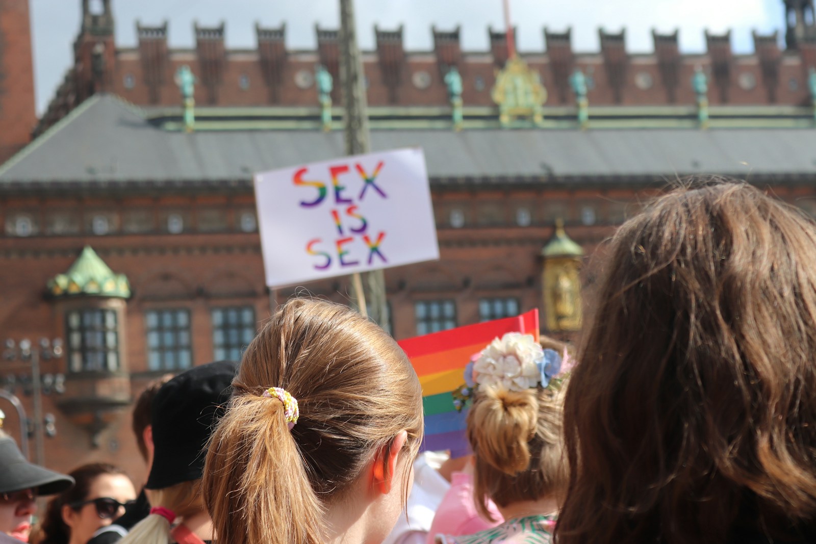 a group of people standing around each other holding signs