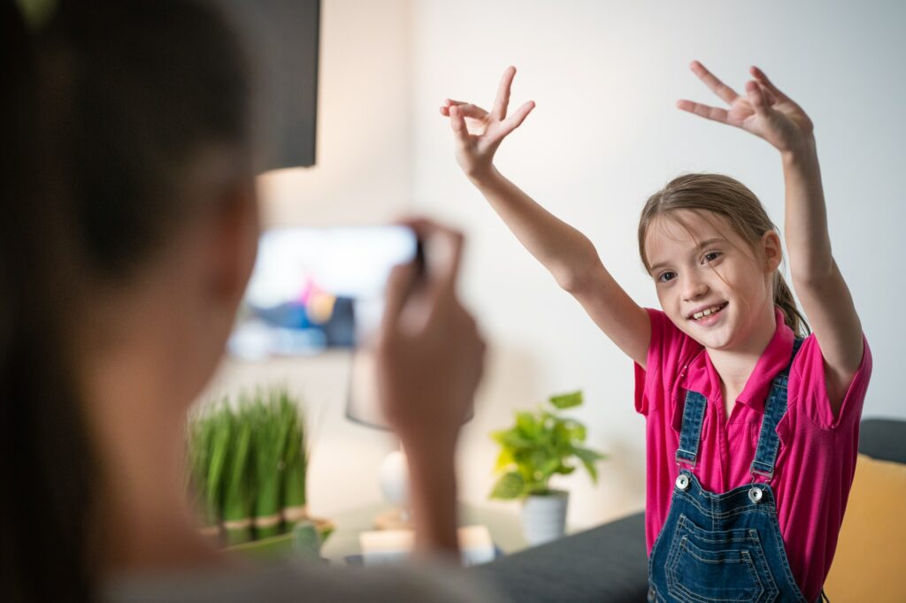 Girl Filming With Smartphone Camera Her Little Sister Dancing