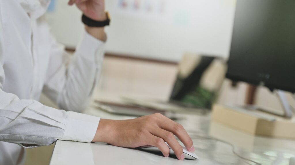 Programmer hand using computer mouse,Computer concept,Computer on programmer desk.