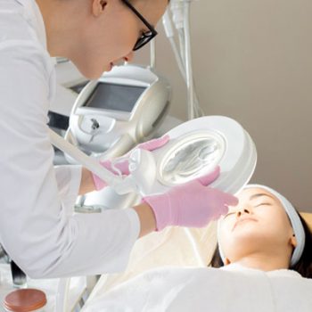 cosmetologist-inspecting-skin-4JLMTVK