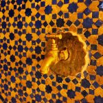 Golden Tap and Tiled Wall in Fes, Morocco