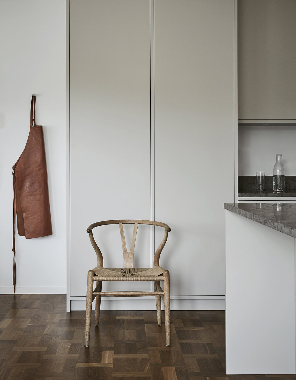 apron and chair in a minimalistic kitchen by Sundlingkicken for Nordiska Kök