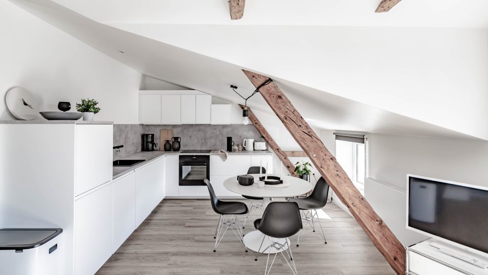 Grey kitchen cabinets against sage green walls in an attic apartment - COCO  LAPINE DESIGNCOCO LAPINE DESIGN