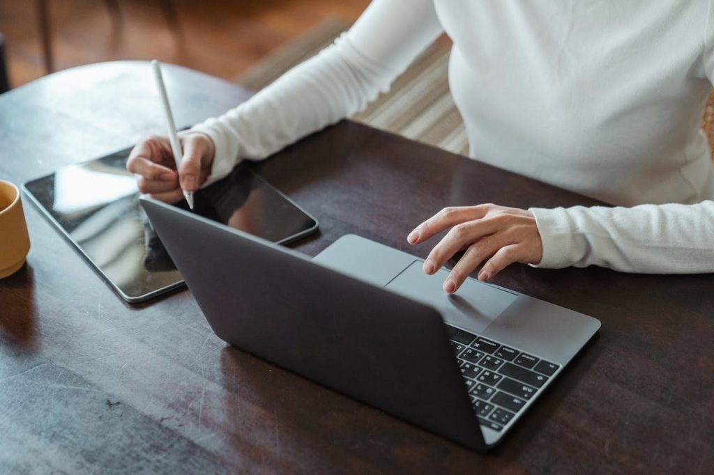 pexels-photo-4474033 Crop faceless female entrepreneur doing multitasking work on different devices