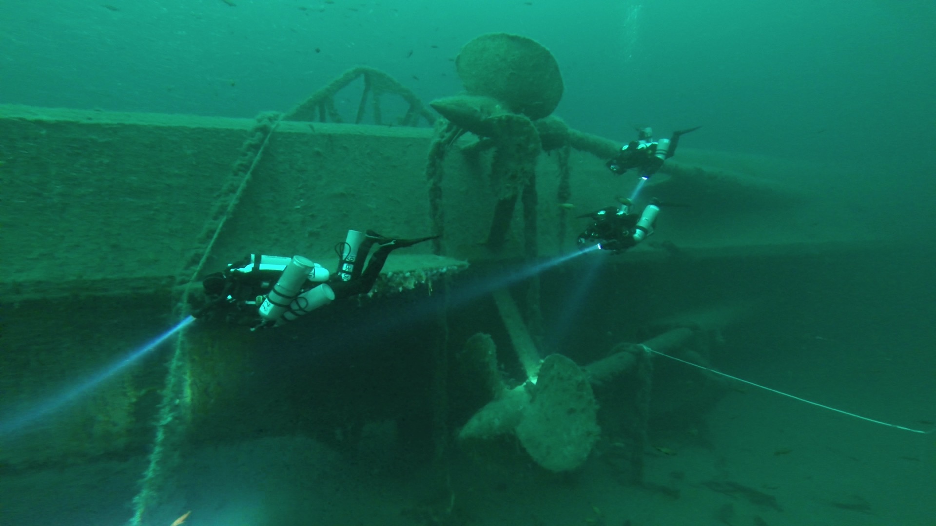 The Wreck of Erich Giese, Narvik, Norway. 3 divers looking at the propellers. 