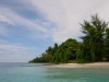 Small beach within blue water mangroves