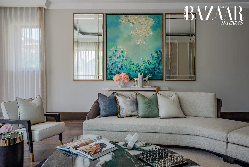 Jewel tones inject energy as they flow through the artwork and cushions in the living area