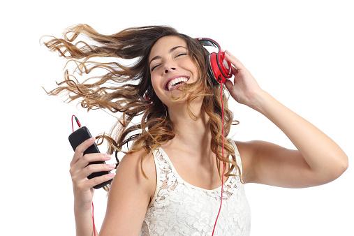 bayan Happy girl dancing and listening to the music isolated on a white background