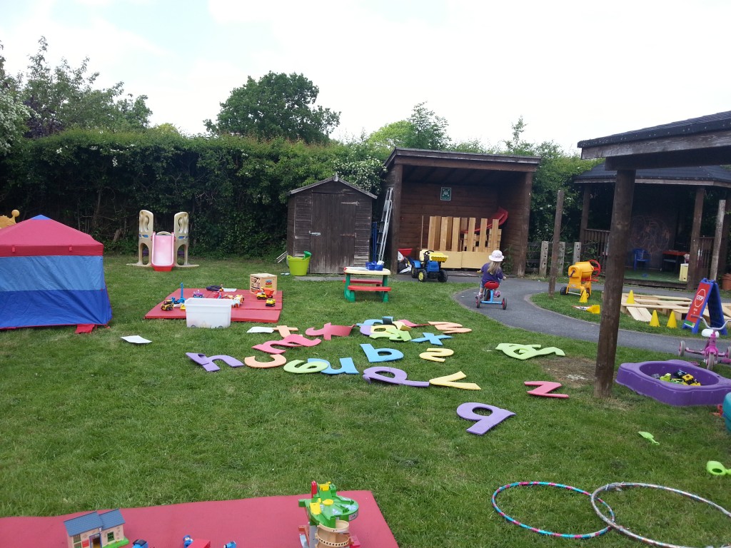 The outdoor play area with foam letters on the floor