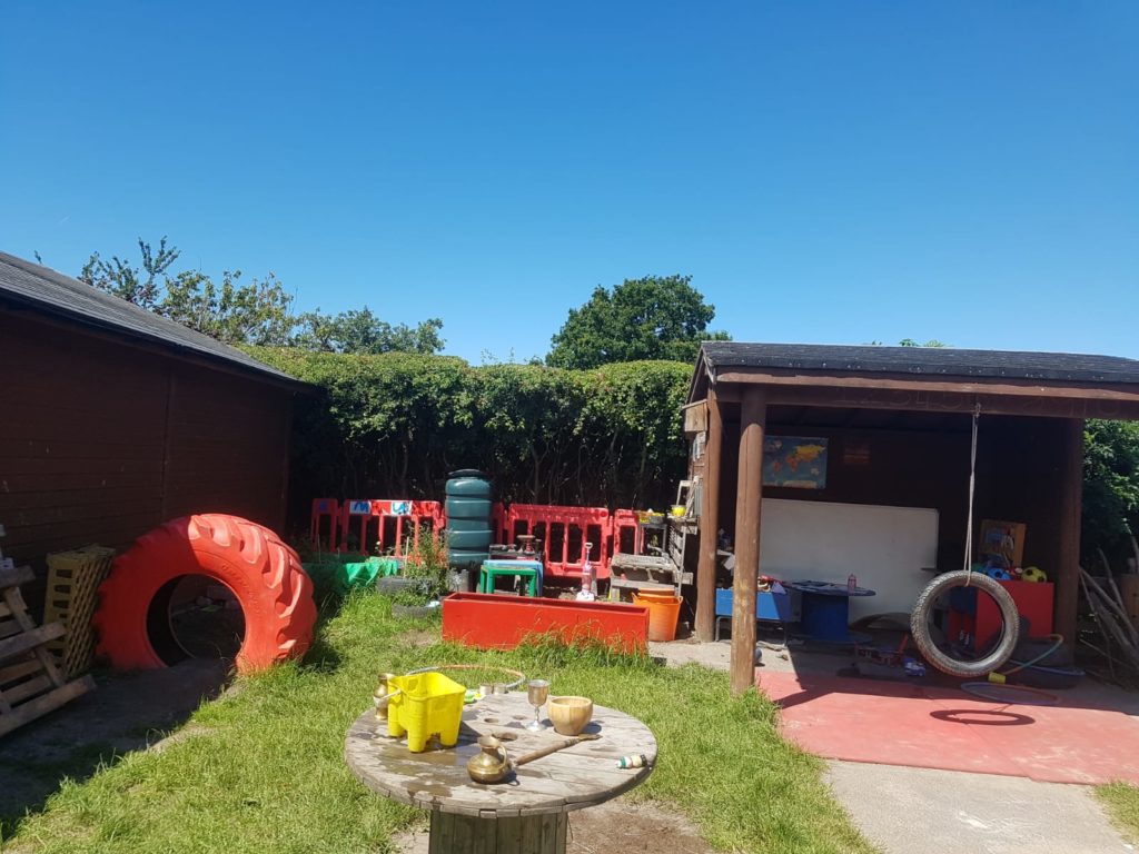 The outdoor play area complete with tyre swing and water butt