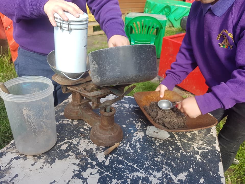 Children learning to balance and weigh items