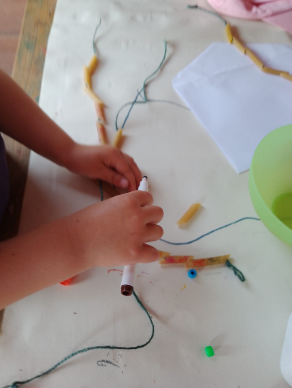 A child colouring in pasta