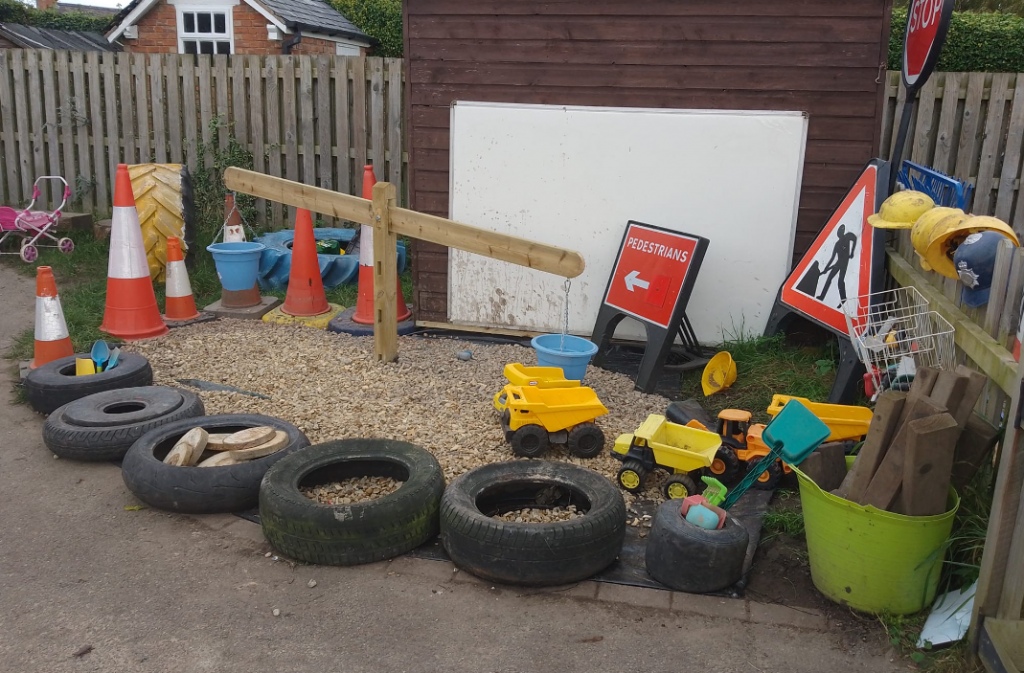 Tyres and road signs on an area of chipped bark at Dodleston Pre-School