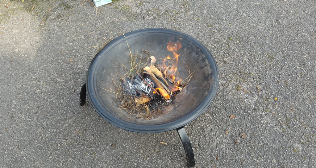 A fire pit filled with a couple of logs