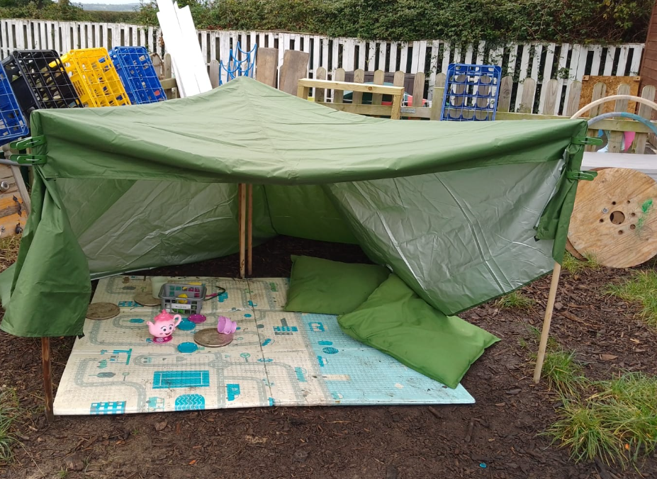 A tarp held up by wooden poles