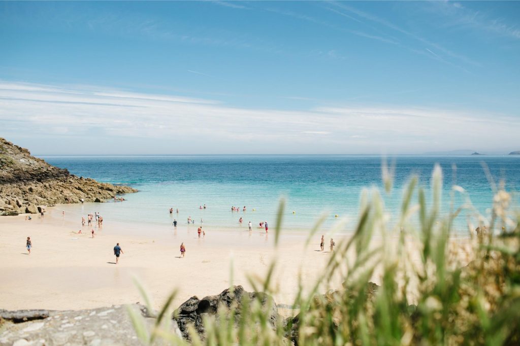 People on the beach in Cornwall for the summer