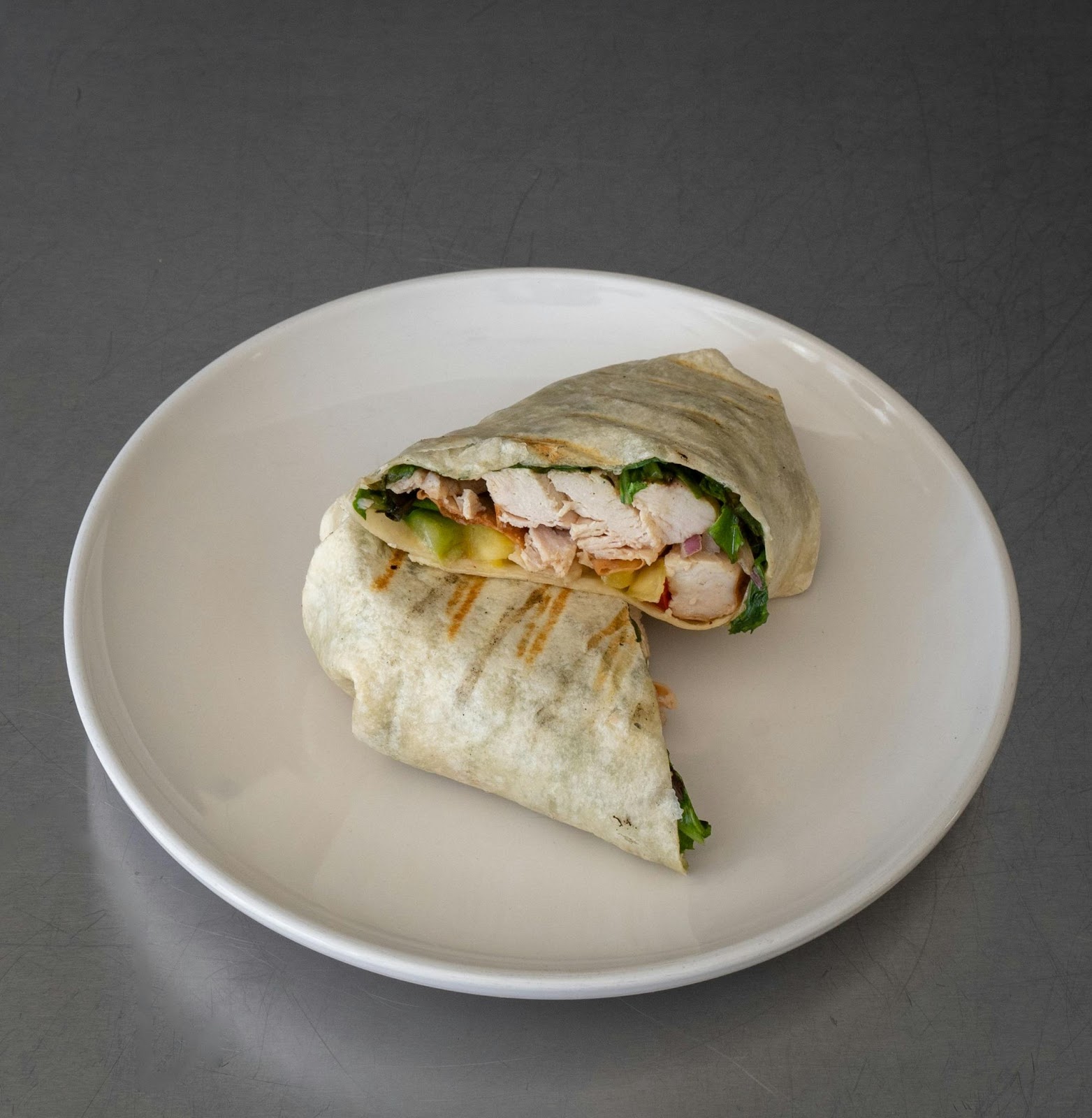 A chicken and avocado wrap on a plate