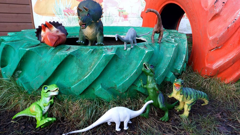 The herd of donated dinosaurs sat inside a green tyre