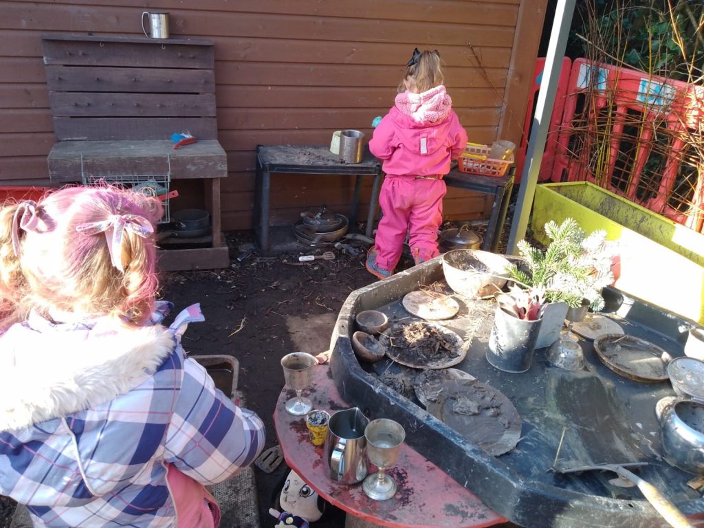 Girls playing in the Dodleston Pre-School mud kitchen