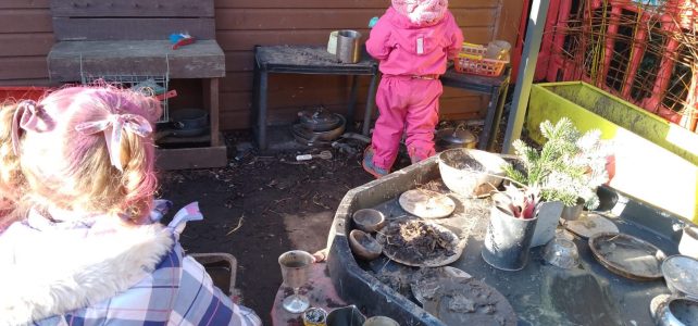 Girls playing in the Dodleston Pre-School mud kitchen