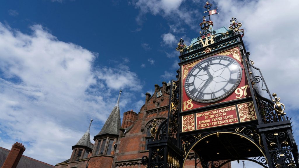 Chester's Eastgate clock up close with a blue sky behind it
