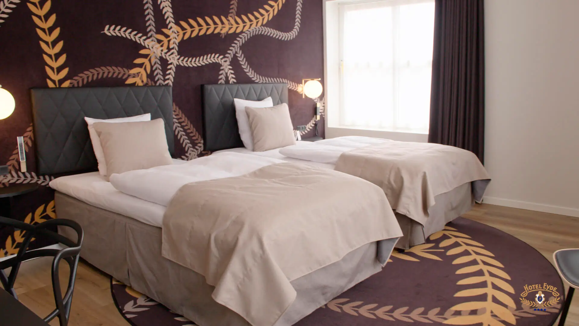 Hotel Eyde Herning hotel værelser indretning og leverandør bestående af elegante værelser i høj kvalitet med flos væg lamper og her ses på senge ved siden af hinanden der kan skubbes sammen til to
