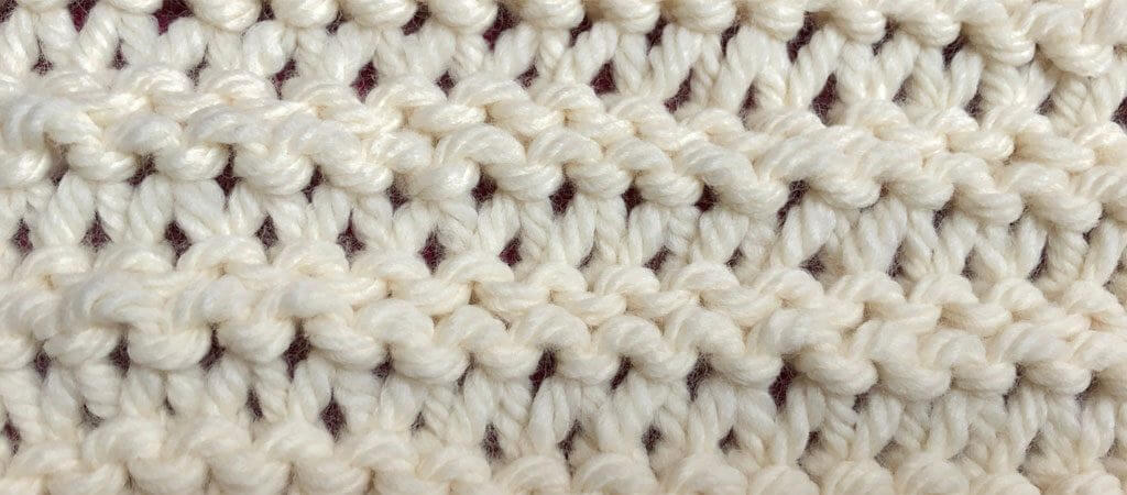 Yarn over garter knitting stitch