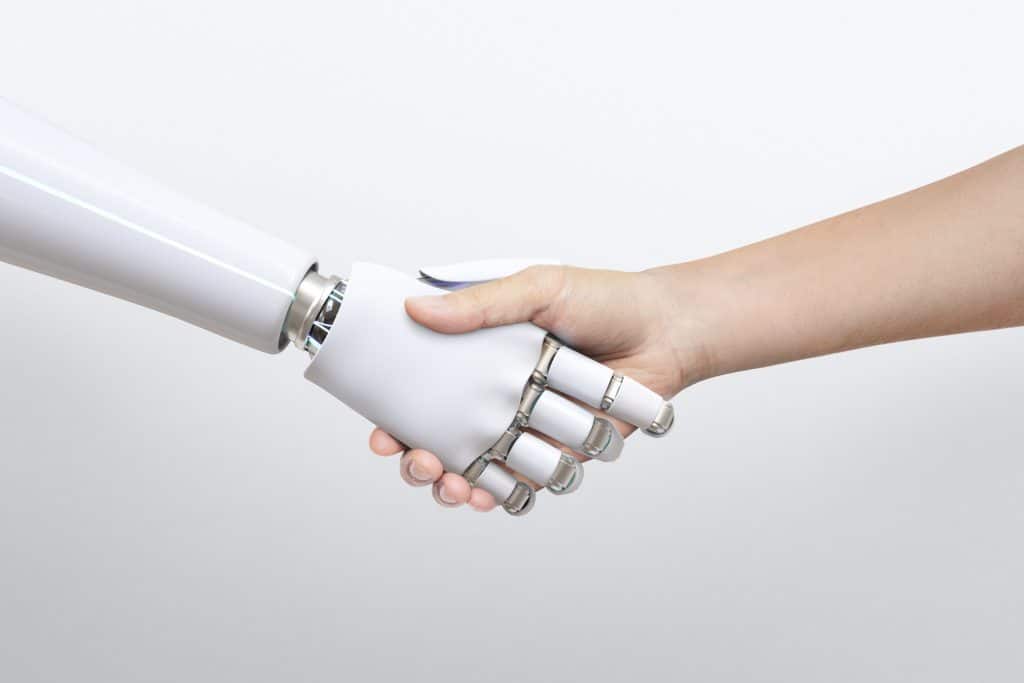 Robot and human shaking hands.